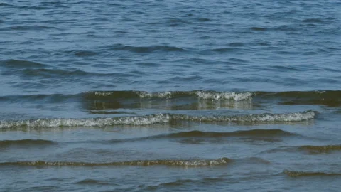 Waves slowly come ashore Stock Footage 98253392