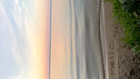 Waves slowly roll on the sandy shore at dawn. The concept of tranquility Video stock 202957076