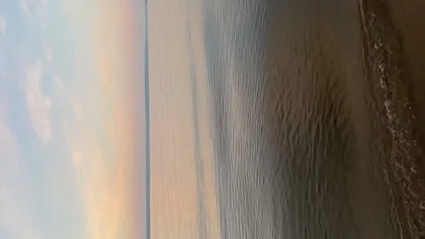 Waves slowly roll on the sandy shore at dawn. The concept of relax Video stock 202957392
