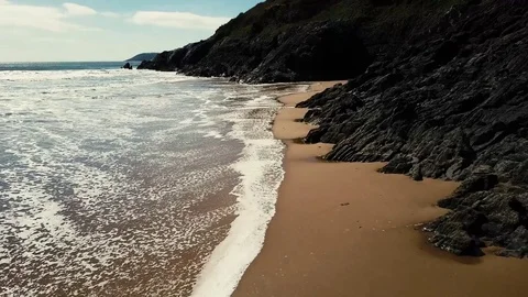 Waves slowly rolling onto sandy beach Stock-Footage 82868717