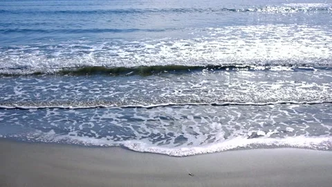 Waves slowly run over the sandy beach Video stock 144582332