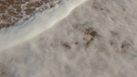 Waves slowly wash over the shells on the sandy beach Video stock 138226196