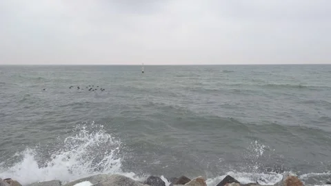 Waves on the snowy beach during winter in Gdynia, Poland. December 2023. Stock Footage 258888186