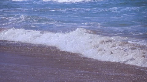 Waves spilling onto the beach in slow motion 250 fps Stock Footage 87703292