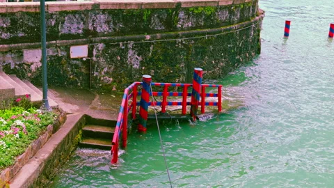 Waves splash against a stone pier on a Borromean island Stock Footage 308459650