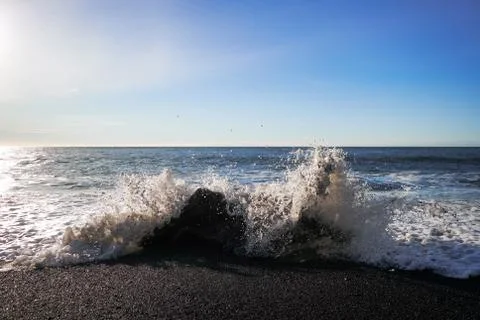 Waves splash on black sand beach Vik Reynisfjara Reynisdrangar Iceland Atlantic Stock Photos