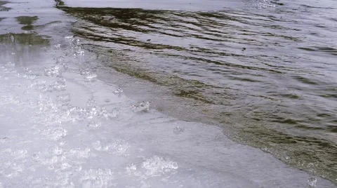 Waves splash at the edge of the ice Video stock 60976889