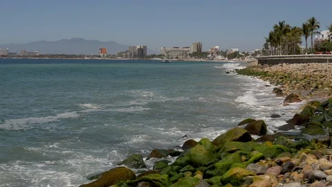 Waves splash Malecon Boardwalk Puerto Vallarta city in back ground Stock-Footage 107007218