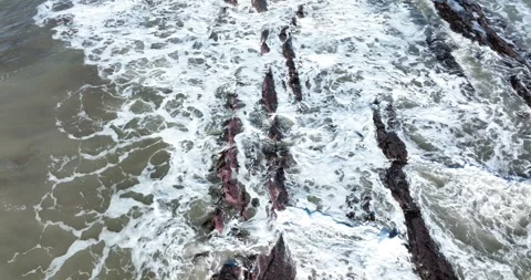 Waves splash over rocks off the coast of Aberystwyth town Stock-Footage 264845936