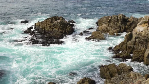 Waves splash on rocks on sea shore, Monterey Bay, California Stock Footage 220955273