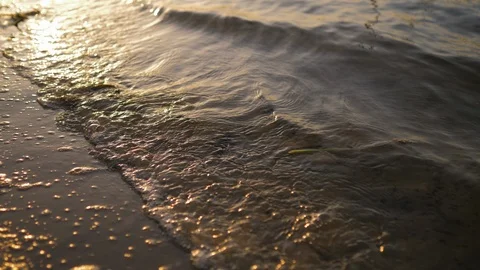 Waves splash on the sandy bank of the river close up Stock Footage 119535618