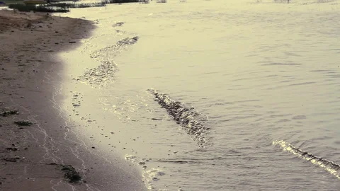 Waves splash on the sandy bank of the river close up. Stock Footage 128165859