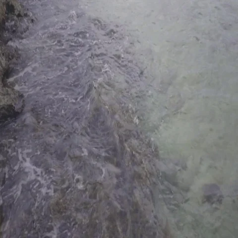 Waves Splash Onto Shallow Rocky Shore Stock Footage 69699691