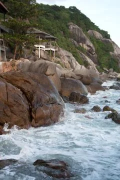 Waves splashes on cliff rocks Stock Photos