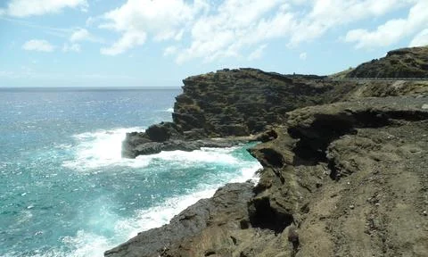 Waves Splashing Against the Cliffs on Oahu Stock Photos