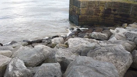 Waves splashing against rocks Stock Footage 126353698