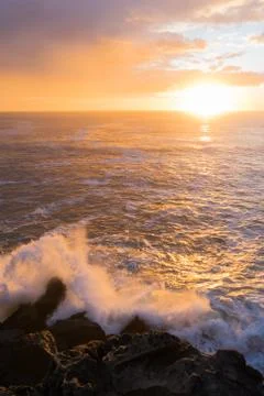 Waves splashing and sunset Stock Photos