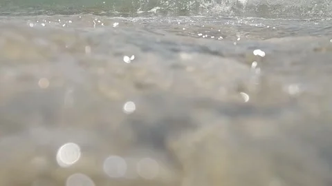 Waves splashing on the beach and hitting the camera Video stock 317395312