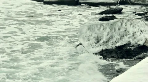 Waves splashing at the ice covered rocks Video stock 55425074