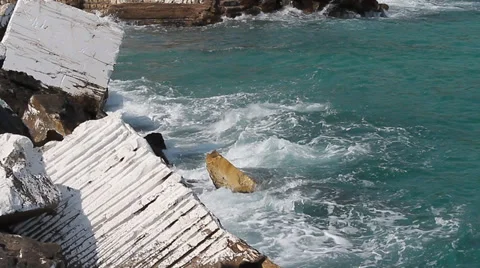 Waves splashing into marble blocks in Greek Island Stock-Footage 30709142