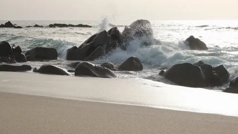 Waves splashing over rocks on beach in slow motion Stock Footage 172485159