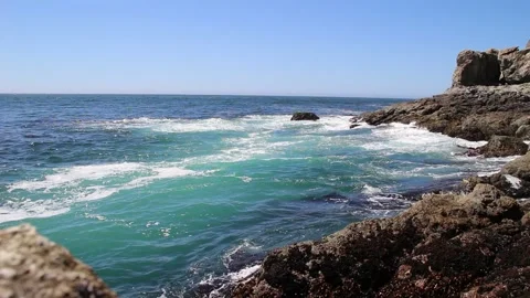 Waves splashing over rocks at the ocean shore Stock Footage 125929512