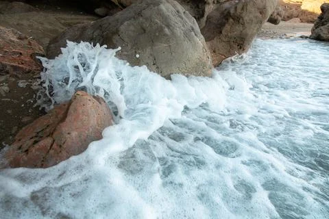 Waves splashing over rocks at the ocean Stock Photos