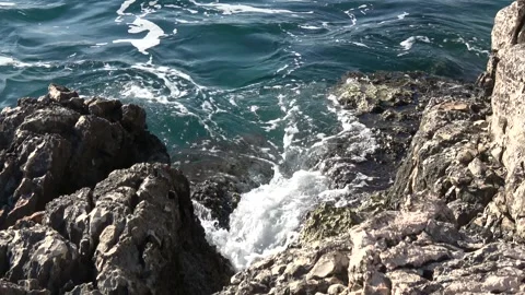 Waves splashing over rugged limestone coastal rocks Video stock 342394346