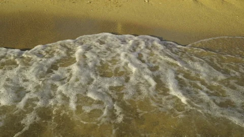 Waves splashing on pebble beach Video stock 212933076
