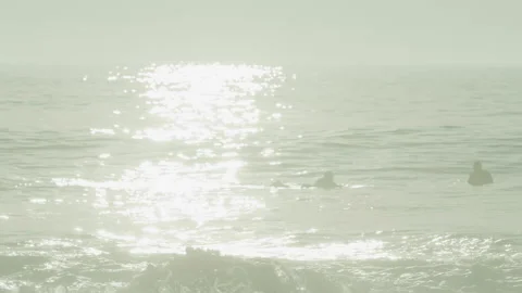 Waves Splashing On Rock With Surfers In Background Stock Footage 273787265