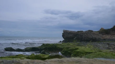 Waves splashing on rocks at the ocean on a cold winters day Stock Footage 94478891