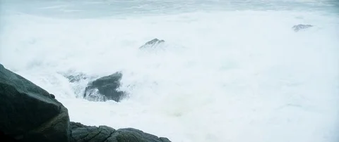 Waves splashing on rocks in slow motion Stock Footage 83826464