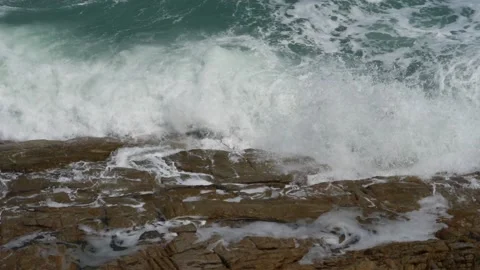Waves splashing on rocks in sunny windy day Stock Footage 138335699