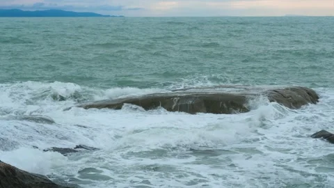 Waves splashing on rocks in sunny windy day Stock Footage 170096388