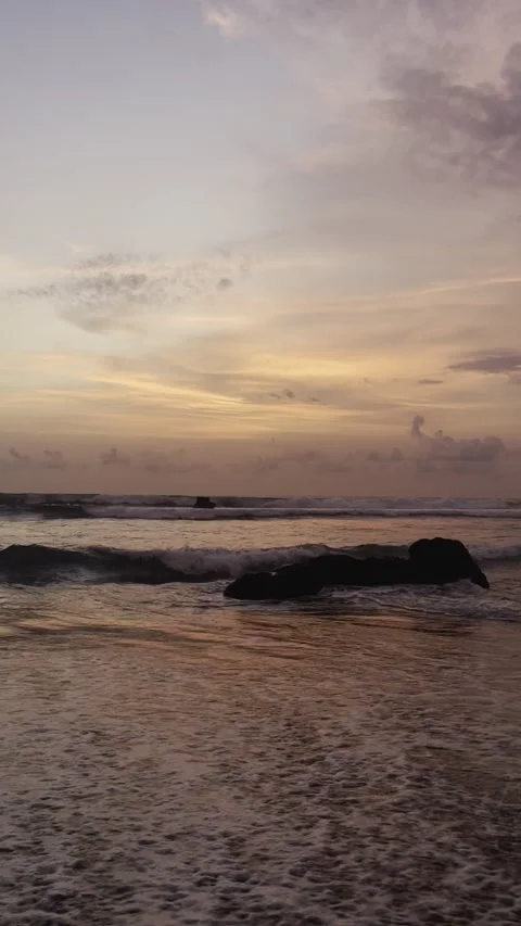 Waves splashing on rocks at sunset Stock Footage 283816569