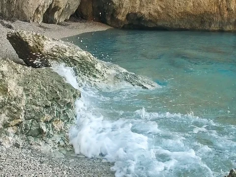 Waves splashing on a rocky beach in Lefkada, Greece. Slow Motion Stock Footage 80064818