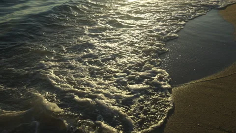 Waves splashing on sand at Beach Stockbeeldmateriaal 212955276