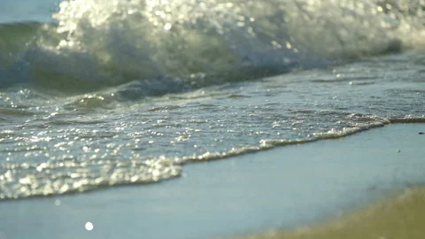 Waves splashing on sand Stockbeeldmateriaal 212858168