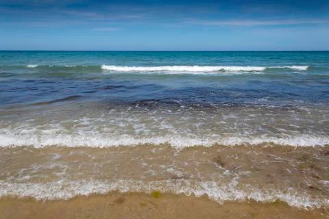Waves Splashing onto a Sandy Beach 写真素材