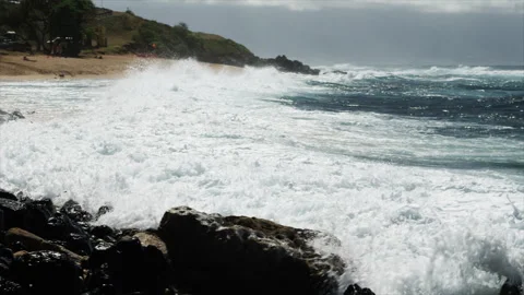 Waves Splashing onto Sandy Rocky Beach Stock Footage 278433311