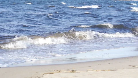 Waves splashing on the sandy shore of the sea Stock Footage 131587494