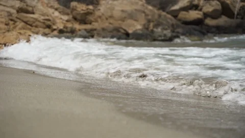 Waves splashing on seashore by rock in slow motion Stock Footage 114497849