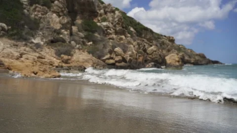 Waves splashing on seashore by rock in slow motion Stock Footage 114497985
