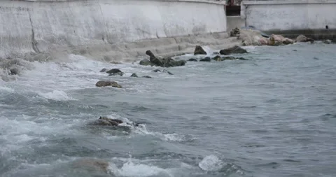 Waves splashing into the small port in Parga city. Windy and cloudy weather cond Stock-Footage 220680209