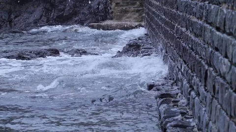 Waves splashing on a stone wall Stock Footage 73927829