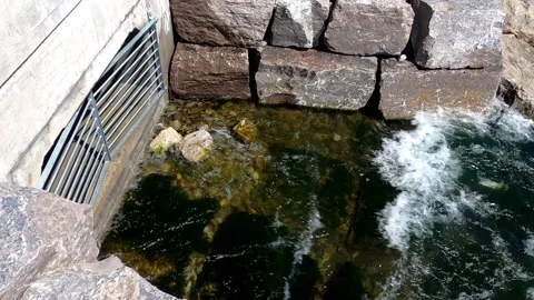 Waves splashing on storm drain with grate. Stock Footage 196776751