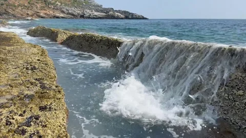 Waves splashing through stone plates on Kory Beach, Alanya Stock Footage 314289607
