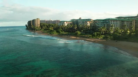 Waves splasing onto the shore of a beautiful resort Stock Footage 163929637