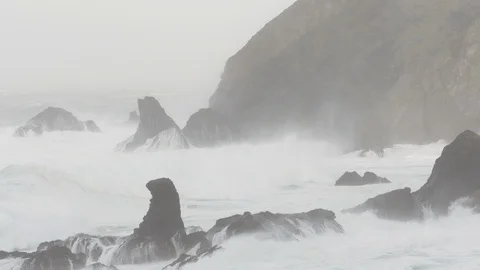 Waves split by Solid Rock Stump at Port, County Donegal Ireland Stock Footage 99475479