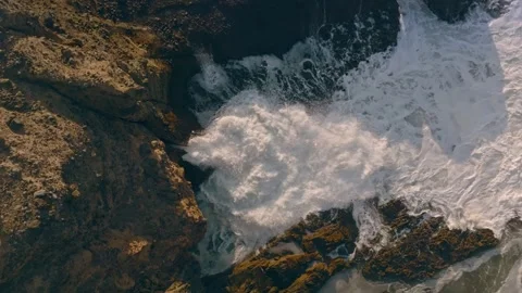 Waves squirting through chutes in rough seas in Piha, Auckland, New Zealand. Stock Footage 278645558
